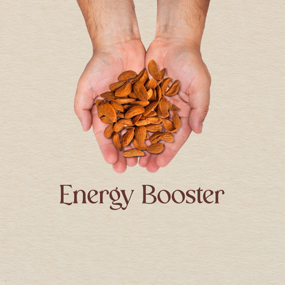 Hands holding a pile of golden-brown almond kernels