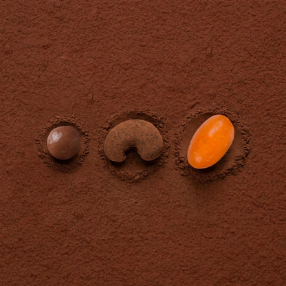 Cocoa-coated chocolate dragees, three assorted pieces: brown and orange