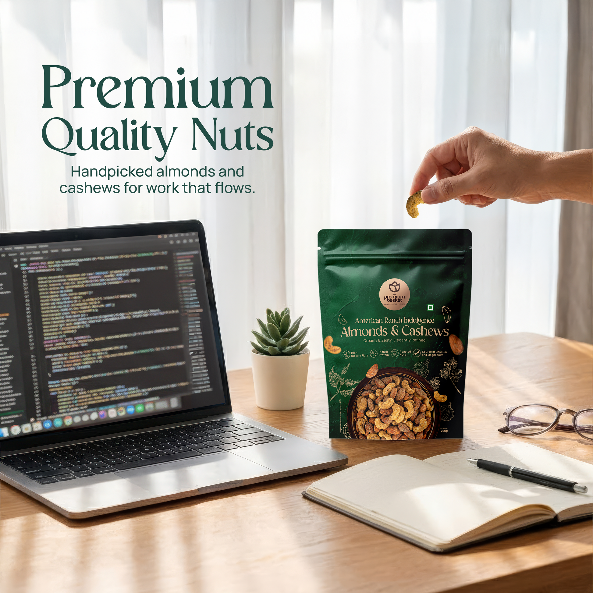 Almonds & cashews snack pouch on a desk next to a laptop and notebook